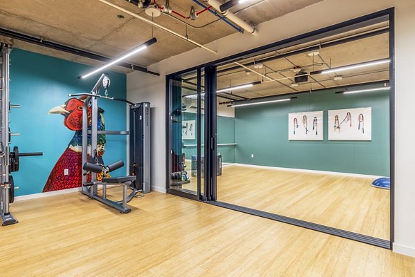 Fully-equipped fitness center at Jackson Apartments featuring modern gym machines and free weights for luxury apartment living