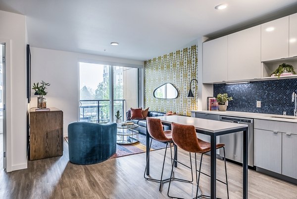Modern kitchen with stainless steel appliances and granite countertops at Jackson Apartments