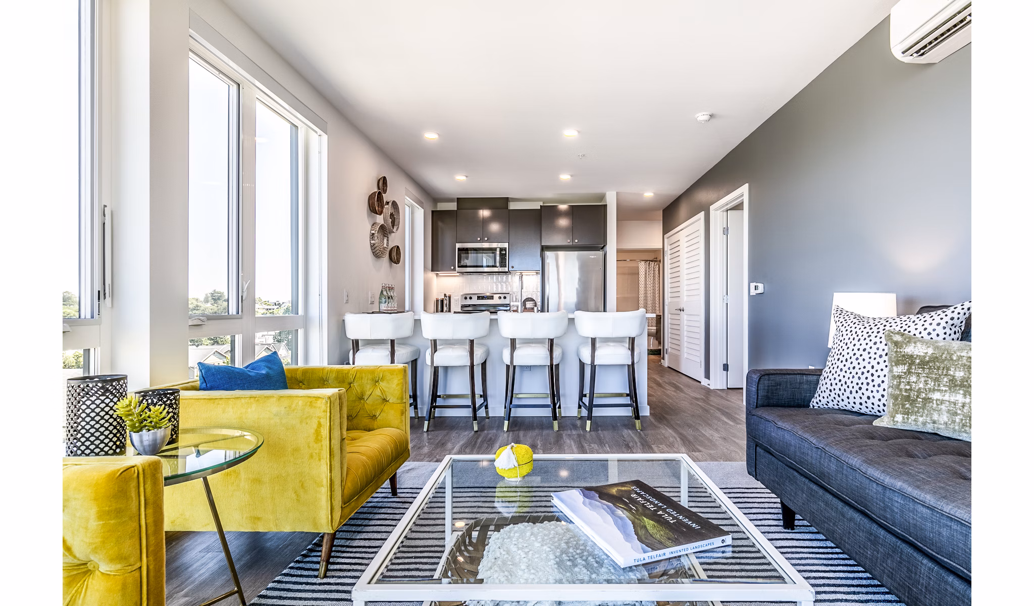 Modern living room with chic furnishings and ample natural light at Jackson Apartments