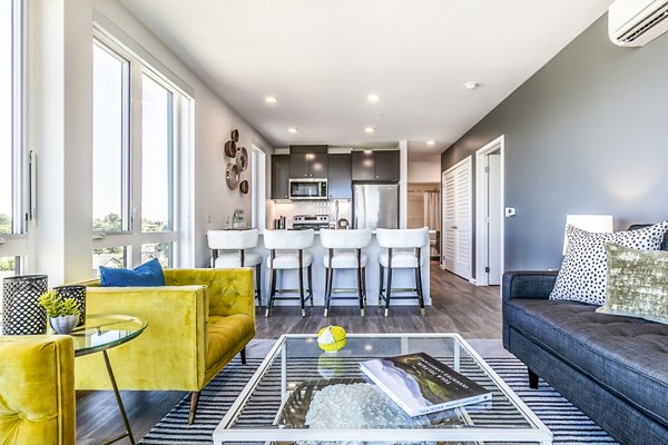 Modern living room with chic furnishings and ample natural light at Jackson Apartments