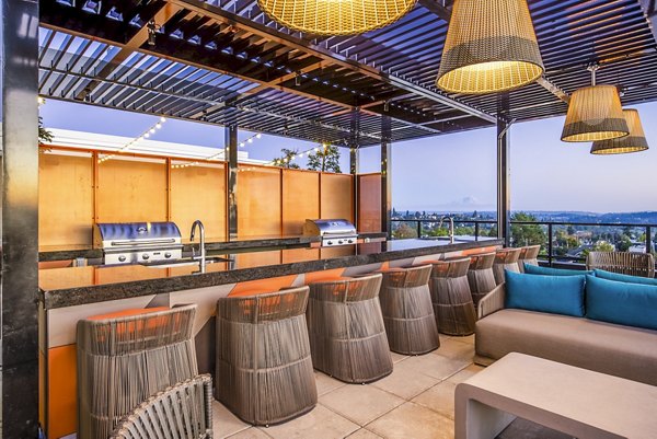 Outdoor grill area with modern seating at Jackson Apartments, perfect for social gatherings and barbecues