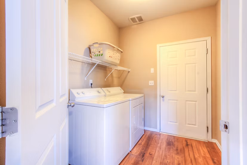 Laundry room featuring modern washer and dryer at Bradley Park Apartments