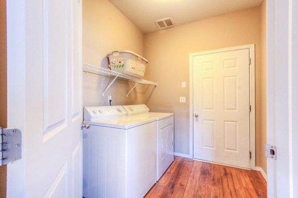 Laundry room featuring modern washer and dryer at Bradley Park Apartments