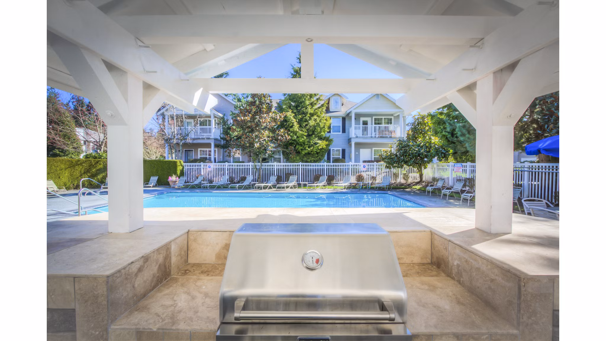 Community pool and grill area at Bradley Park Apartments offers leisure and entertainment for residents