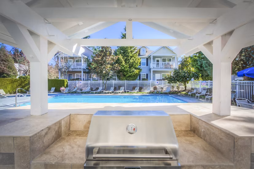 Community pool and grill area at Bradley Park Apartments offers leisure and entertainment for residents