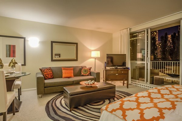 Open-concept living room with modern furnishings and natural light at The Gateway Apartments luxury property