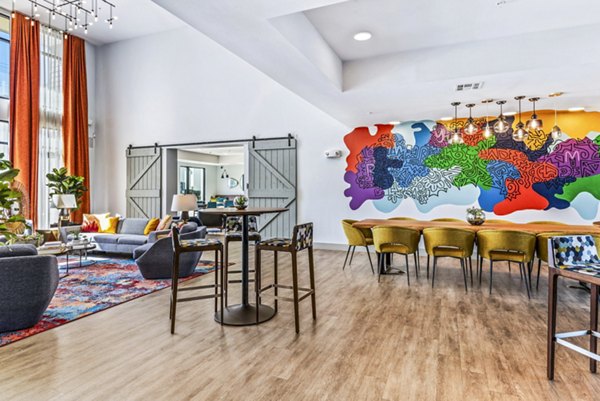 Clubhouse lobby featuring modern seating and artwork in Rhythm Apartments