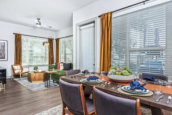 Dining room with modern decor and elegant lighting at Rhythm Apartments