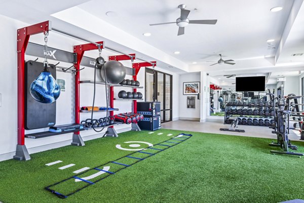 State-of-the-art fitness center with modern equipment at Rhythm Apartments, offering residents luxury workout spaces