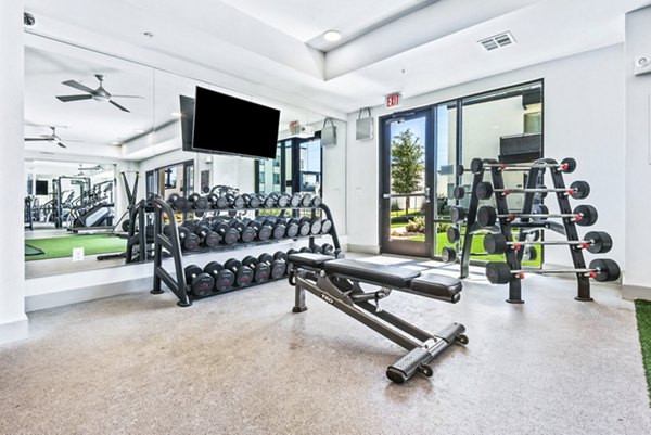 Modern fitness center with advanced equipment at Rhythm Apartments, catering to luxury lifestyle enthusiasts