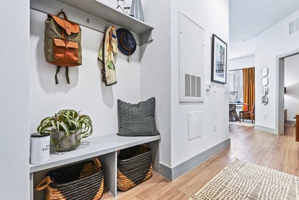 Living room featuring modern decor and natural light at Rhythm Apartments, by Greystar
