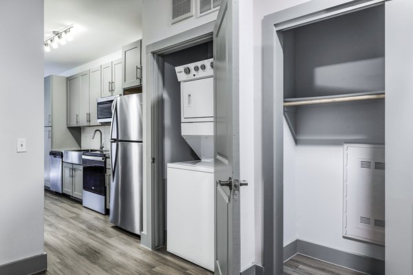 Laundry room equipped with high-efficiency machines at Rhythm Apartments