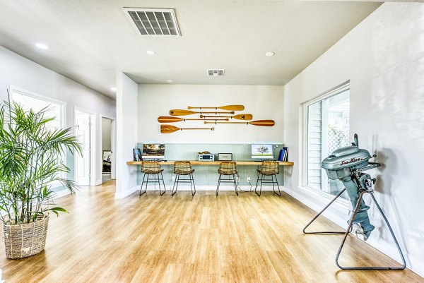 Clubhouse with modern business center at Copper Ridge Apartments featuring workstations and conference table, ideal for luxury apartment living