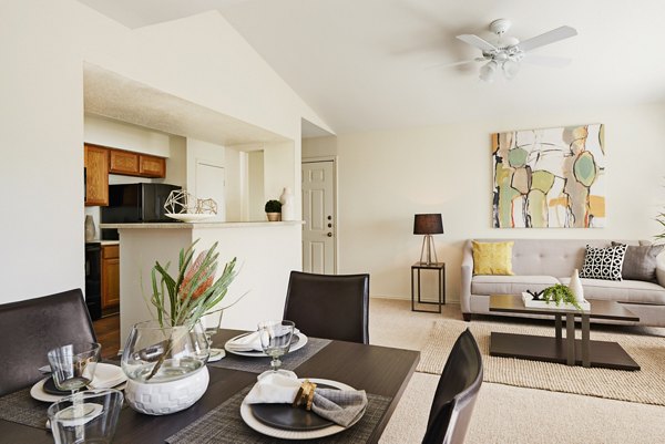 Dining area featuring elegant wooden table and modern lighting at Copper Ridge Apartments