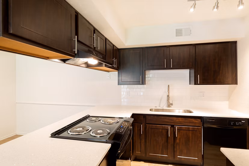 Modern kitchen with granite countertops and stainless steel appliances at Copper Ridge Apartments