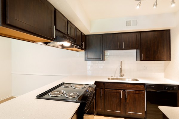 Modern kitchen with granite countertops and stainless steel appliances at Copper Ridge Apartments