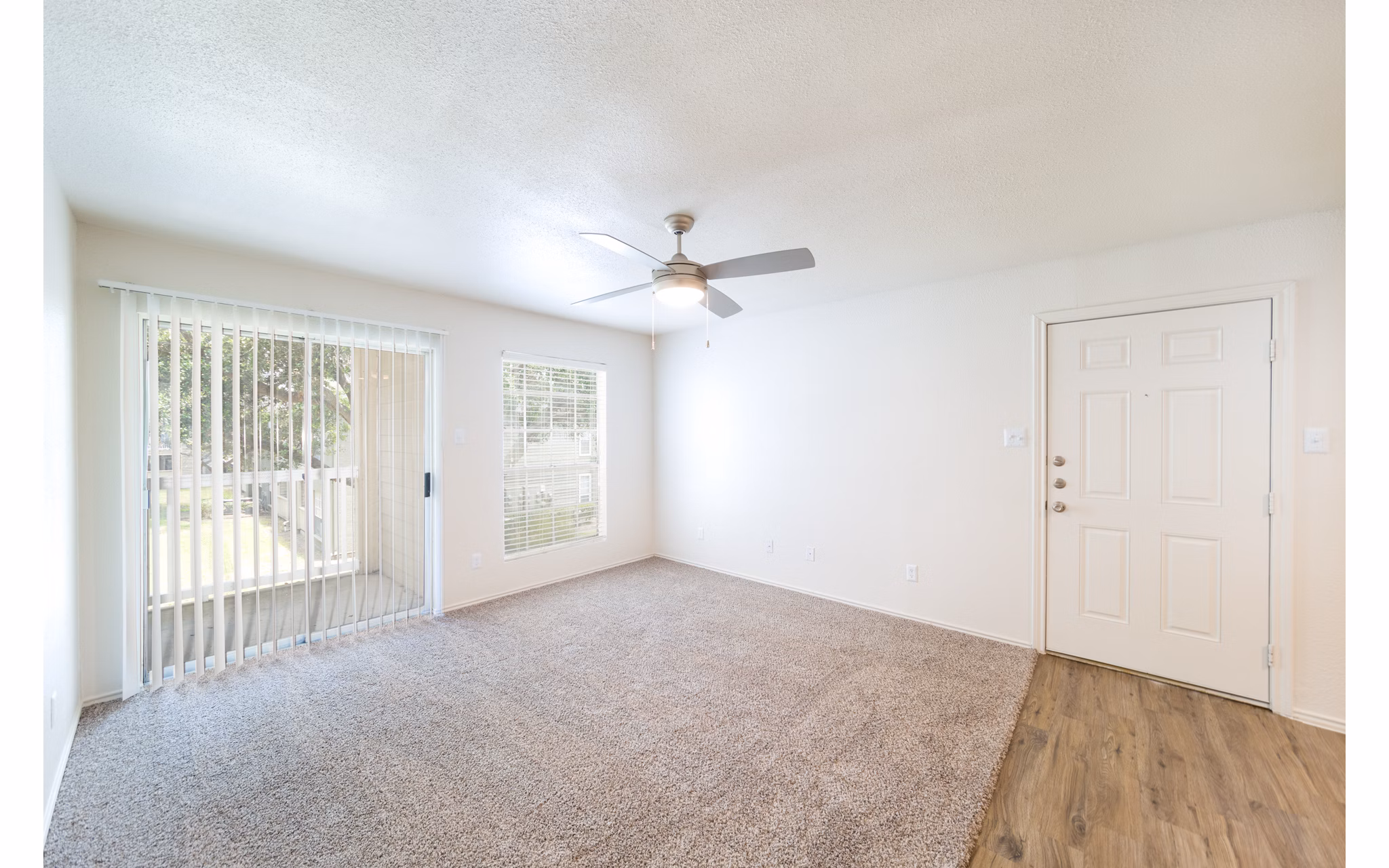 Spacious living room with modern decor and large windows in Copper Ridge Apartments