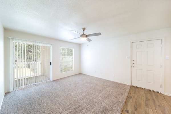 Spacious living room with modern decor and large windows in Copper Ridge Apartments