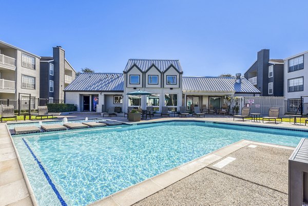 Infinity-edge pool with lush landscaping at Copper Ridge Apartments