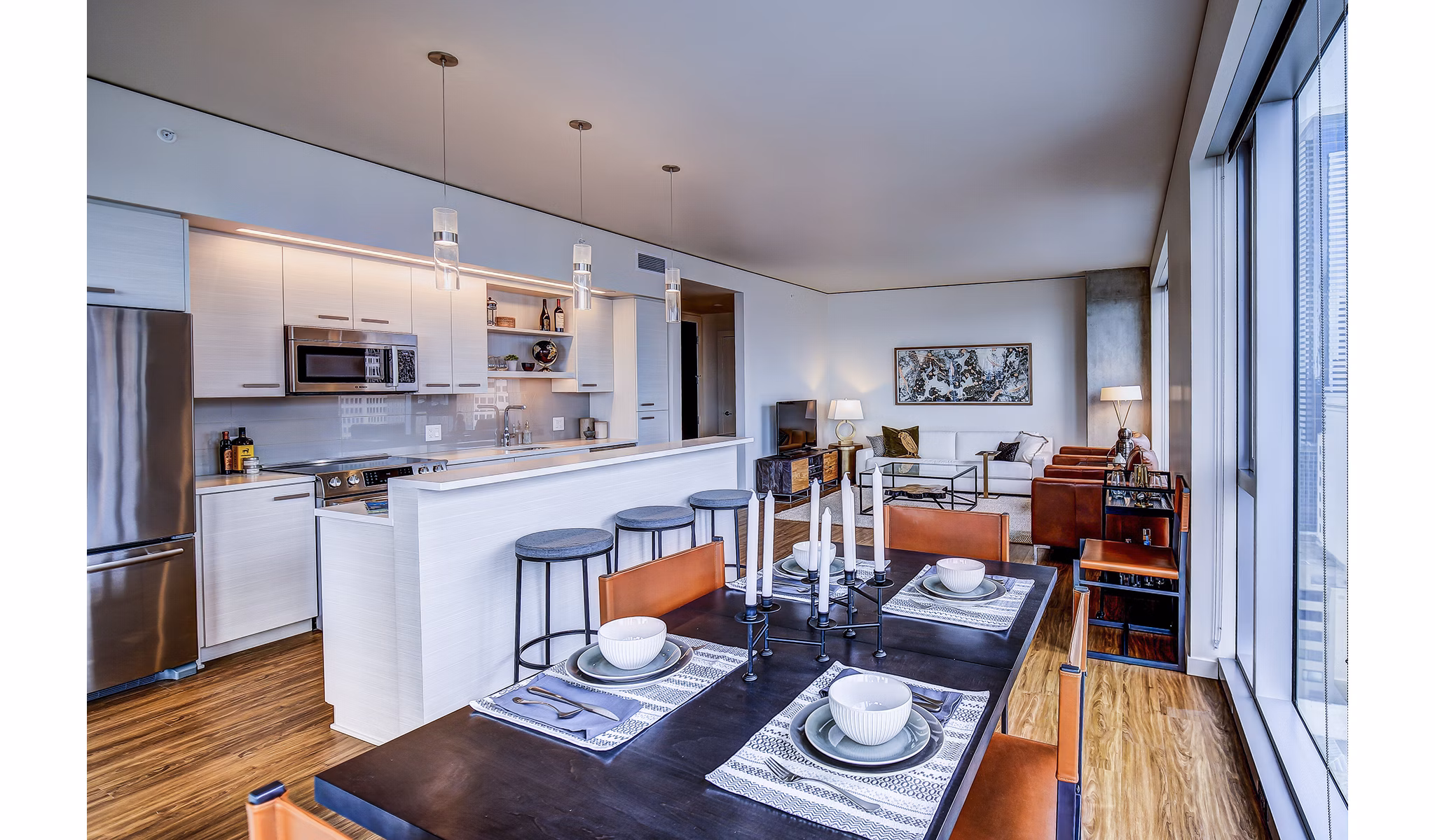 Dining room featuring elegant furnishings and city views at West Edge Apartments