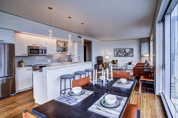 Dining room featuring elegant furnishings and city views at West Edge Apartments