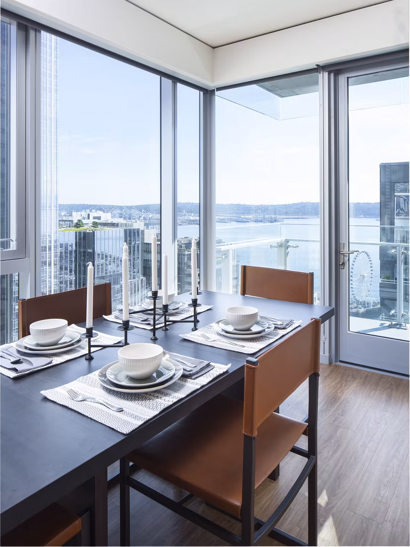 Elegant dining room with modern decor at West Edge Apartments, featuring sleek furniture and contemporary lighting