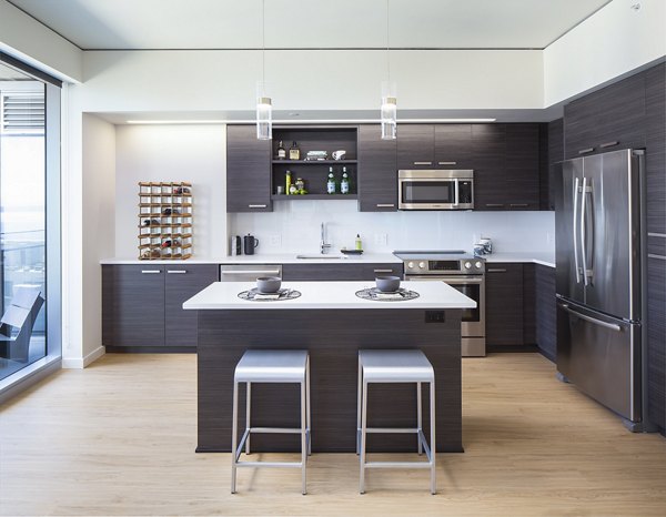 Modern kitchen featuring stainless steel appliances at West Edge Apartments