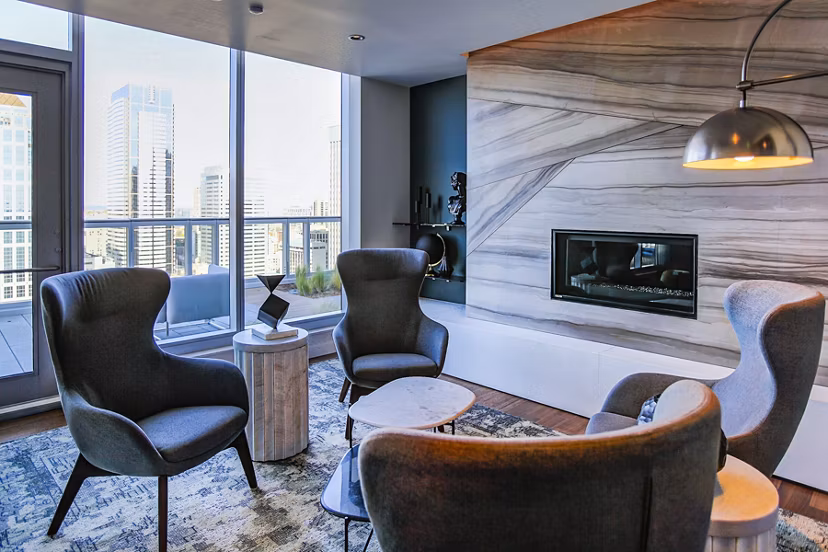 Modern living room with elegant furnishings and city views in West Edge Apartments