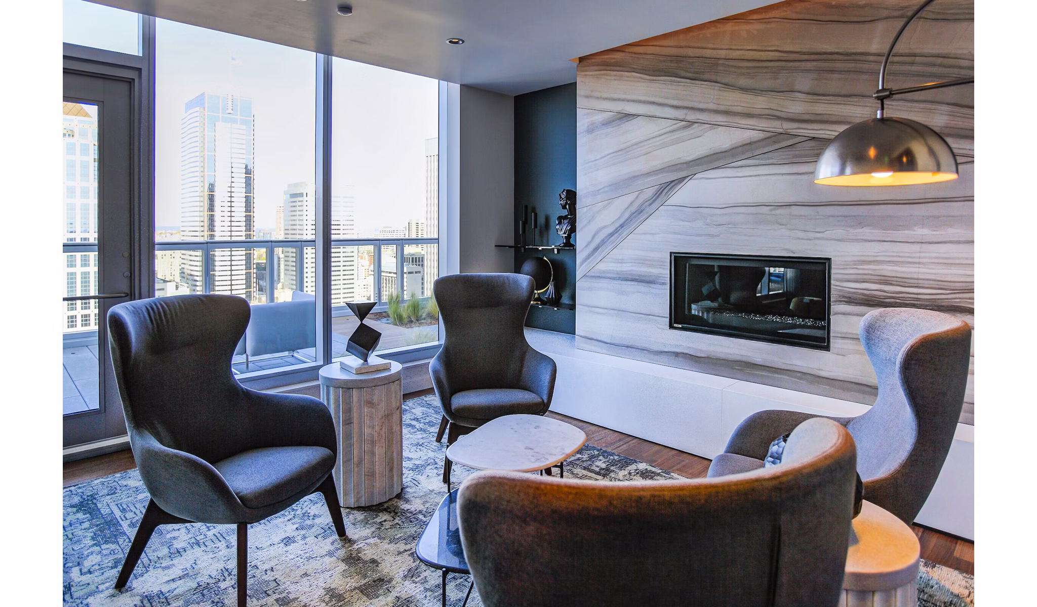 Modern living room with elegant furnishings and city views in West Edge Apartments