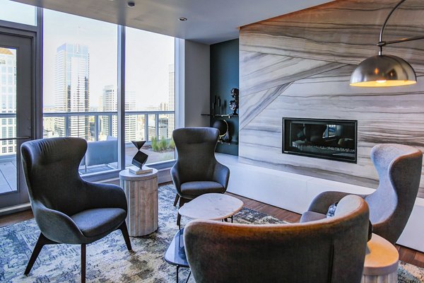 Modern living room with elegant furnishings and city views in West Edge Apartments