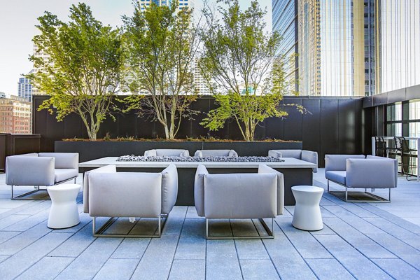 Outdoor fire pit lounge at West Edge Apartments offering cozy gathering space in luxury setting