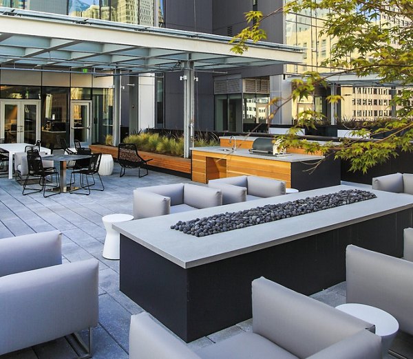Outdoor grill area at West Edge Apartments: Modern amenity space for socializing and dining Perfect for West Edge residents and guests
