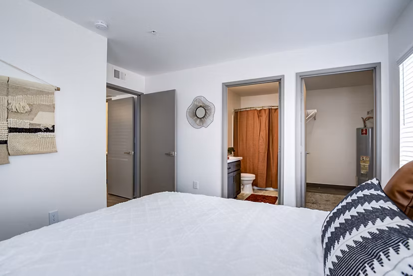 Cozy bedroom with modern decor at Lumen Apartments, highlighting comfort and style in urban living