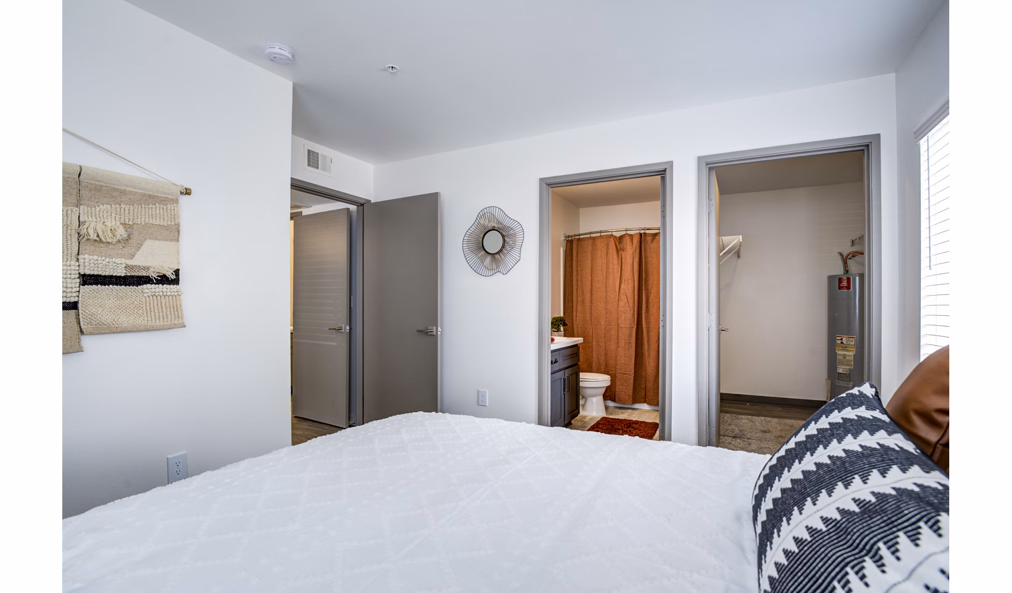 Cozy bedroom with modern decor at Lumen Apartments, highlighting comfort and style in urban living