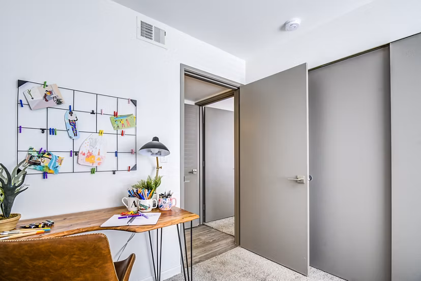 Home office integrated with modern bedroom design at Lumen Apartments