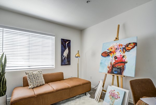 Bedroom/home office with modern furnishings at Lumen Apartments: Luxury living in a versatile space