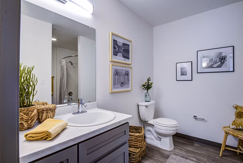 Modern bathroom featuring sleek fixtures and ambient lighting in Lumen Apartments