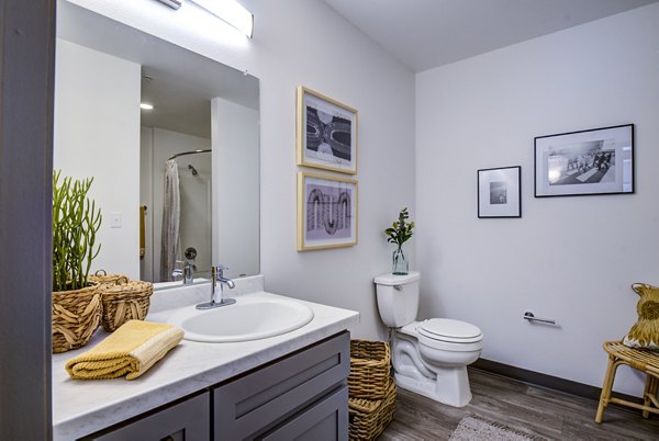Modern bathroom featuring sleek fixtures and ambient lighting in Lumen Apartments