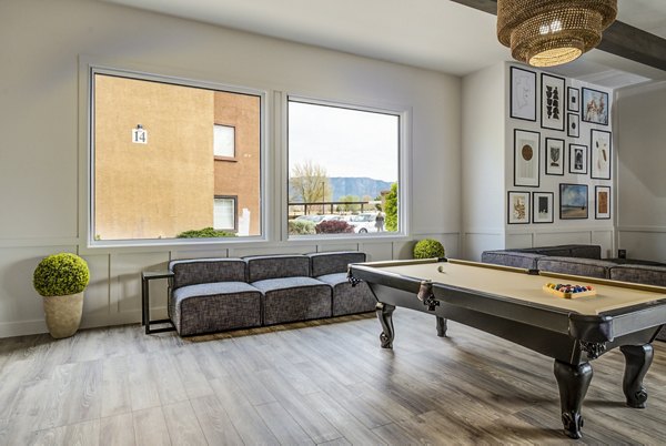 Clubhouse game room at Lumen Apartments with billiards and lounge space, perfect for gatherings and relaxation