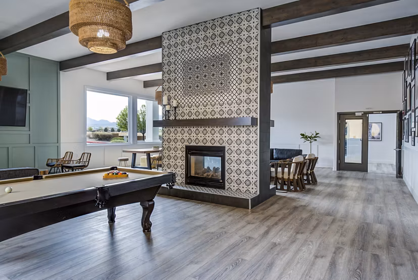Clubhouse game room featuring billiards and modern seating at Lumen Apartments
