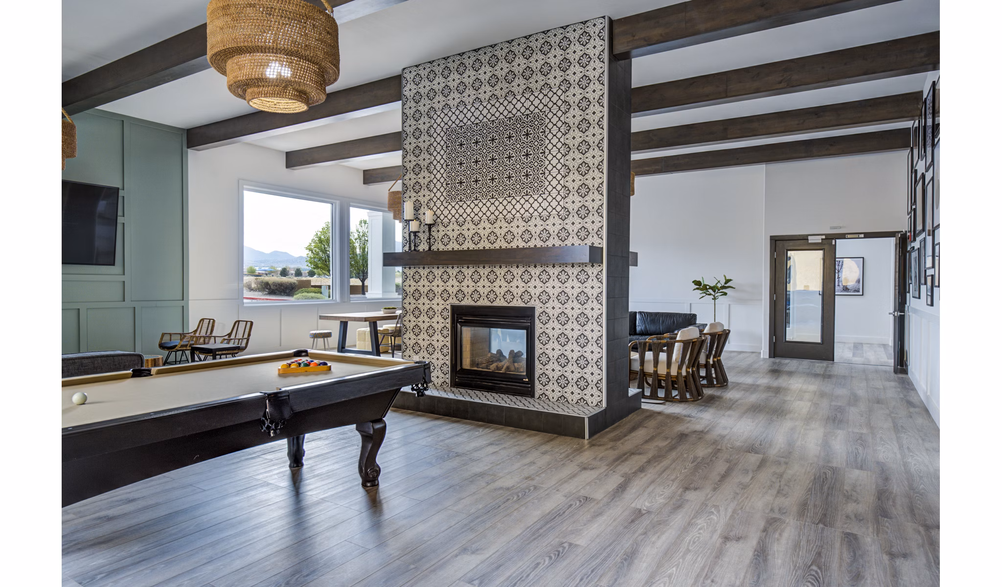 Clubhouse game room featuring billiards and modern seating at Lumen Apartments