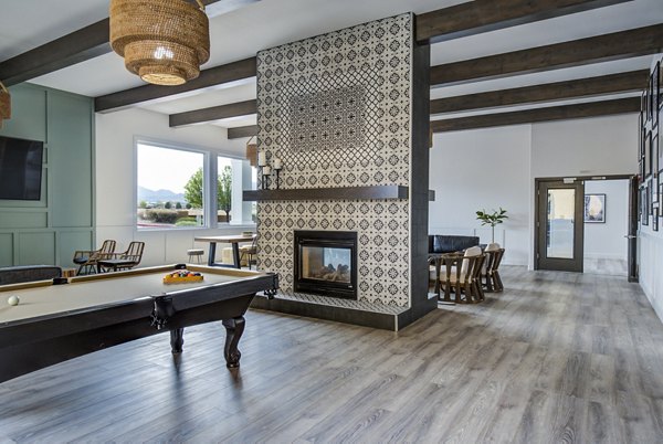 Clubhouse game room featuring billiards and modern seating at Lumen Apartments