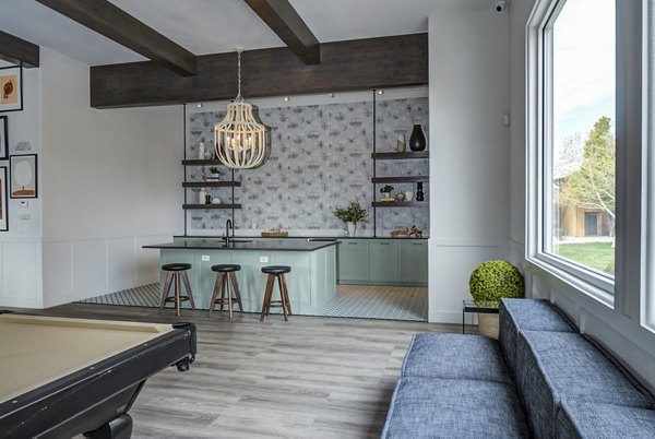 Clubhouse bar with sleek design at Lumen Apartments featuring modern amenities and cozy seating