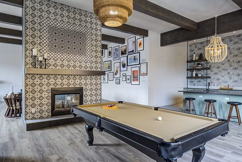 Clubhouse game room with pool table and seating at Lumen Apartments, luxury living by Greystar