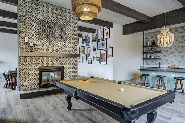 Clubhouse game room with pool table and seating at Lumen Apartments, luxury living by Greystar