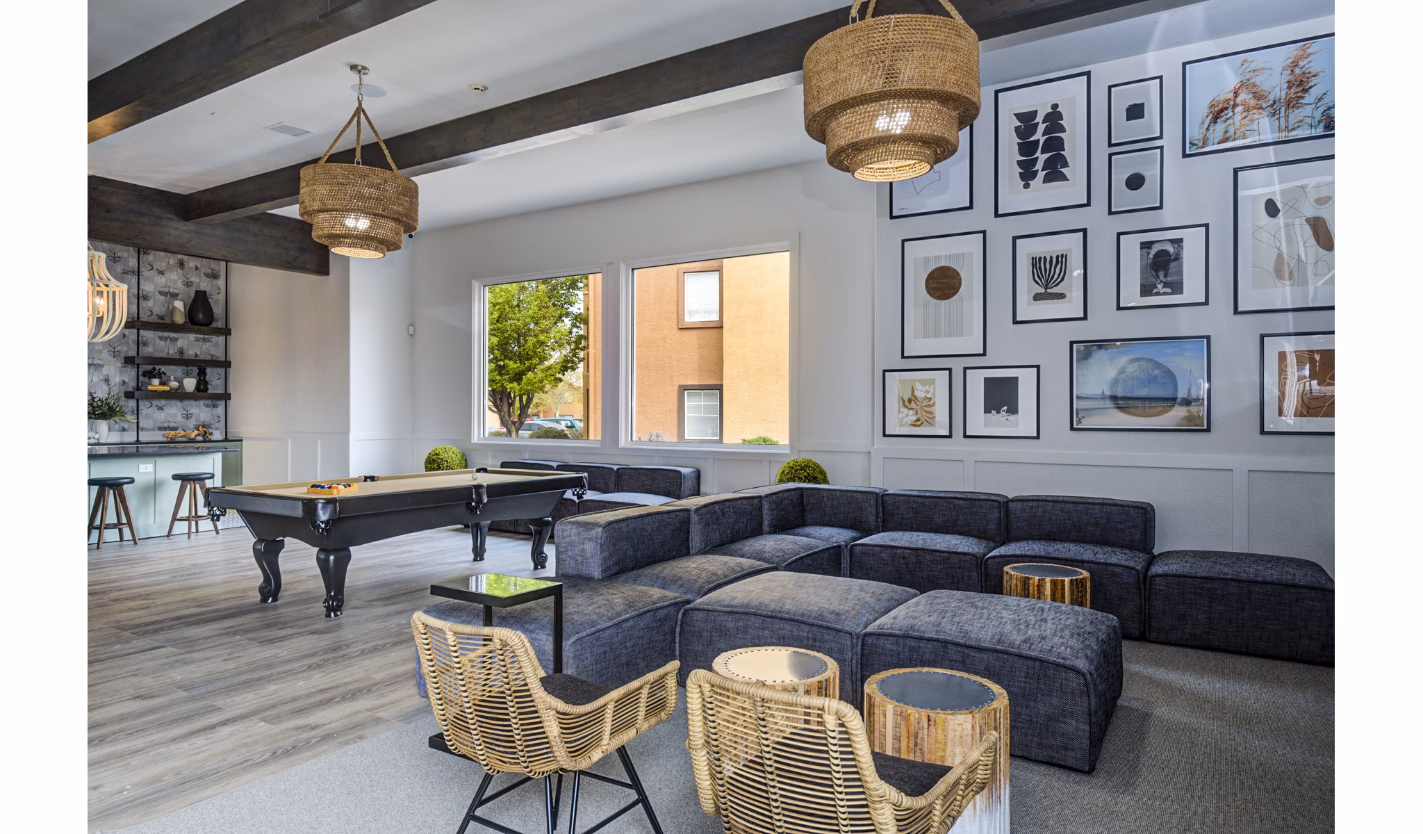 Modern clubhouse game room with pool table at Lumen Apartments, a Greystar luxury community