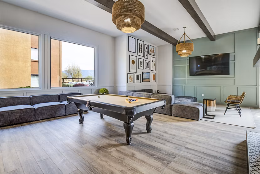 Modern clubhouse game room featuring pool table and lounge seating at Lumen Apartments, luxury living space in Greystar communities