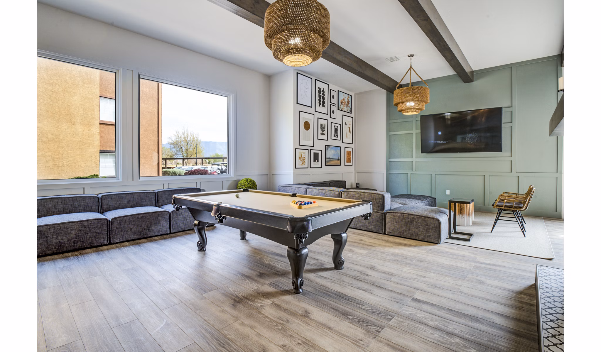 Modern clubhouse game room featuring pool table and lounge seating at Lumen Apartments, luxury living space in Greystar communities