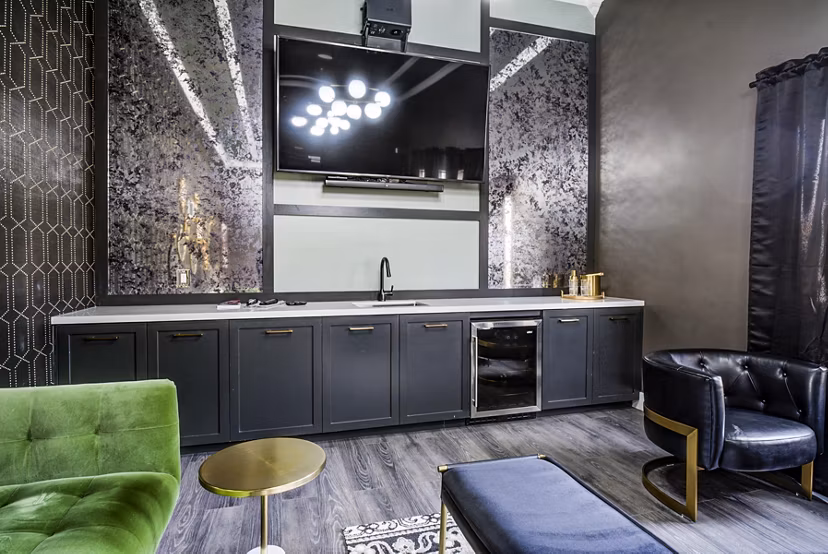 Clubhouse lounge with modern seating and entertainment options at Lumen Apartments, luxury living in a Greystar community