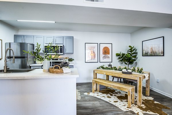 Dining area with modern furnishings and elegant lighting in Lumen Apartments